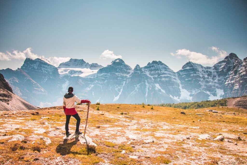 Man Standing on Top of a sunny Mountain