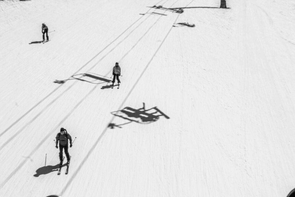 Intermediate skiers skiing on a blue run