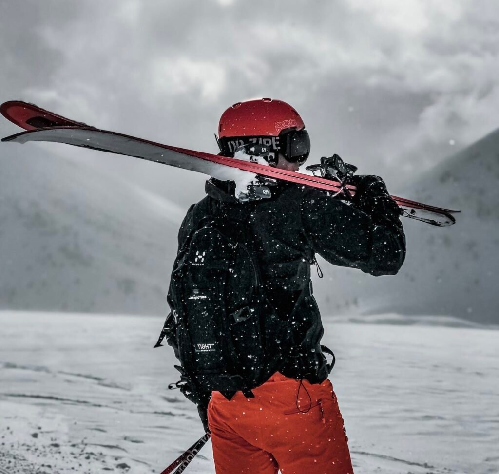 Man Carrying Snow Ski Blades