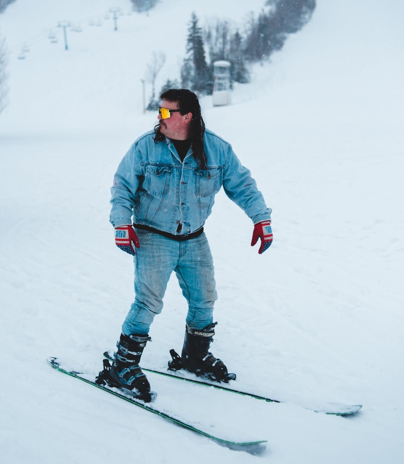 Stylish skier in glasses on snowy slope